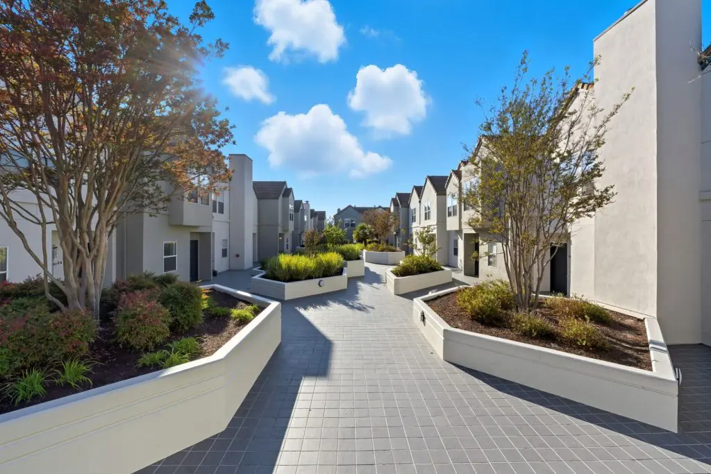 Landscaped residential courtyard and townhome style residences at Stevens Creek Villas in Santa Clara, California.