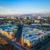 Aerial view of downtown San Jose, California with surrounding neighborhoods and mountains in the distance.