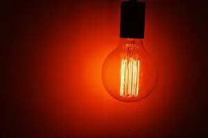 A red light bulb being used as halloween apartment decor.