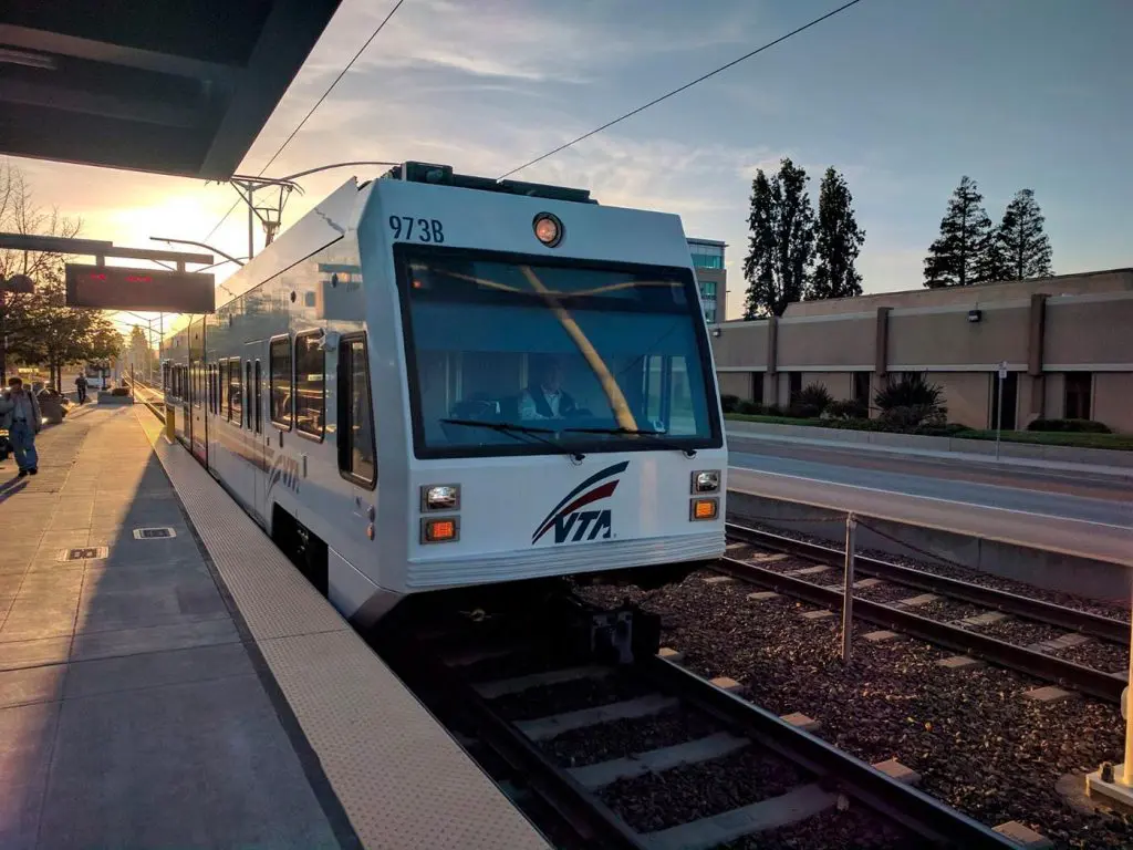 VTA light rail train arriving at Borregas Station in the South Bay at sunset.