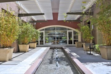Fruitdale Station Apartments Clubroom Front Entrance Water Feature & Landscaping