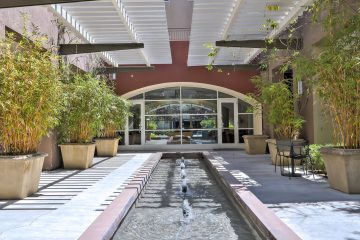 Fruitdale Station Apartments Clubroom Front Entrance Water Feature & Landscaping
