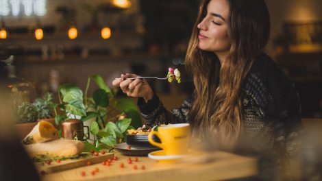 Woman Eating at Restaurant