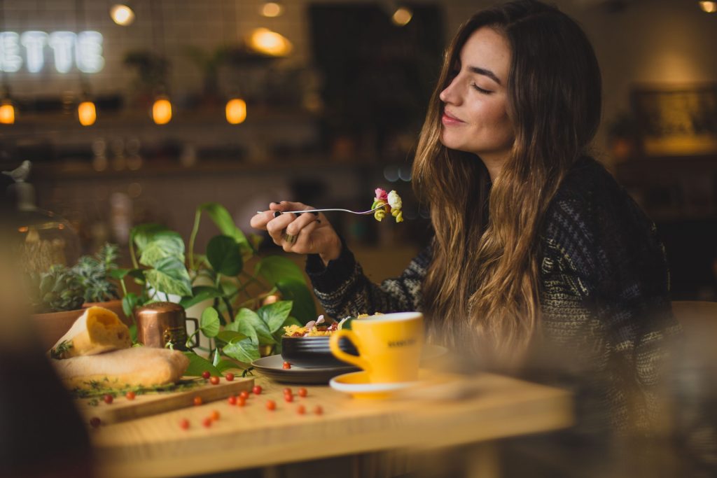 Woman Eating at Restaurant