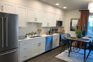 view of kitchen appliances and table of nexus on 9th apartment interior