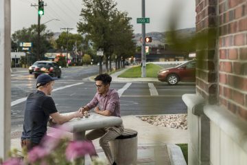 Residents Sitting Outside Costume Property Apartments