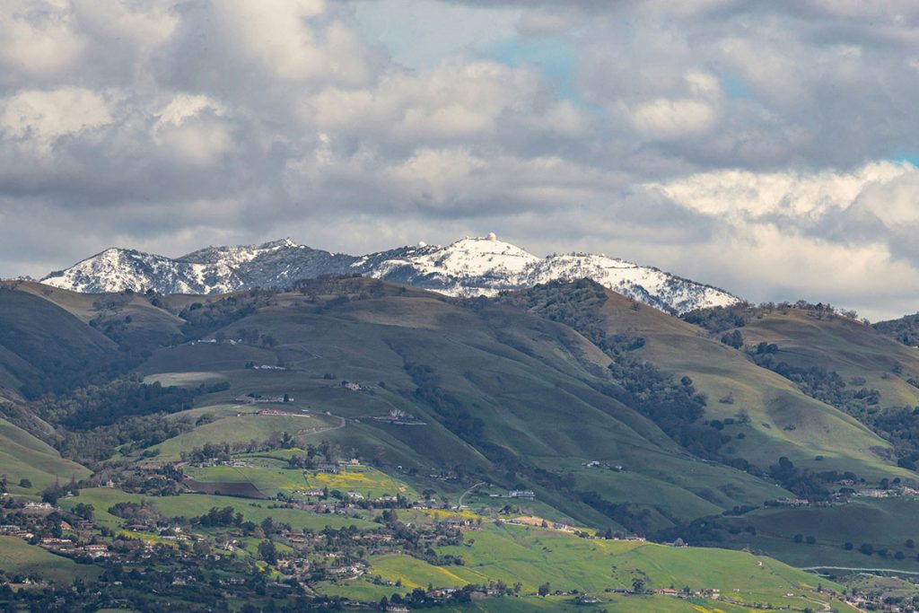 Mount Hamilton with snow capped mountains stretches into the distance.
