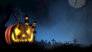 A pumpkin in a graveyard halloween decor.