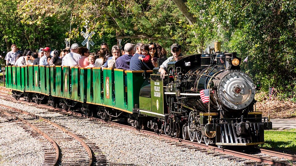 Passengers riding the Billy Jones Wildcat Railroad through Vasona Lake County Park in Los Gatos, California.